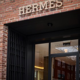 a sign on a brick building with a glass door